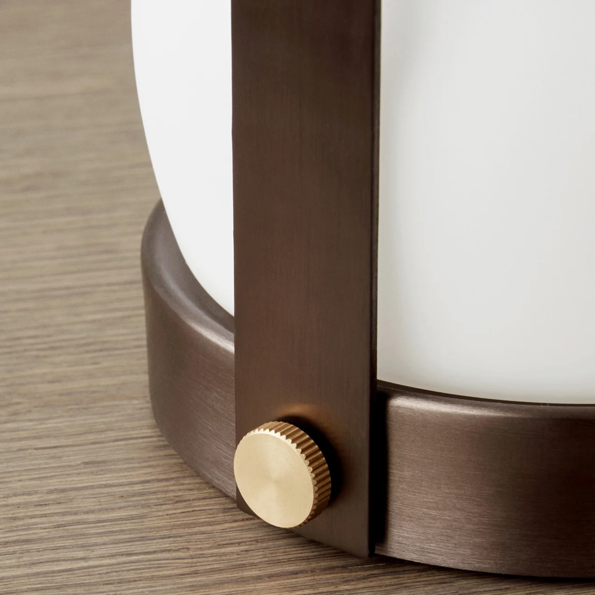 The base of the bronzed brass Carrie Portable Table Lamp from Audo Copenhagen in detail.