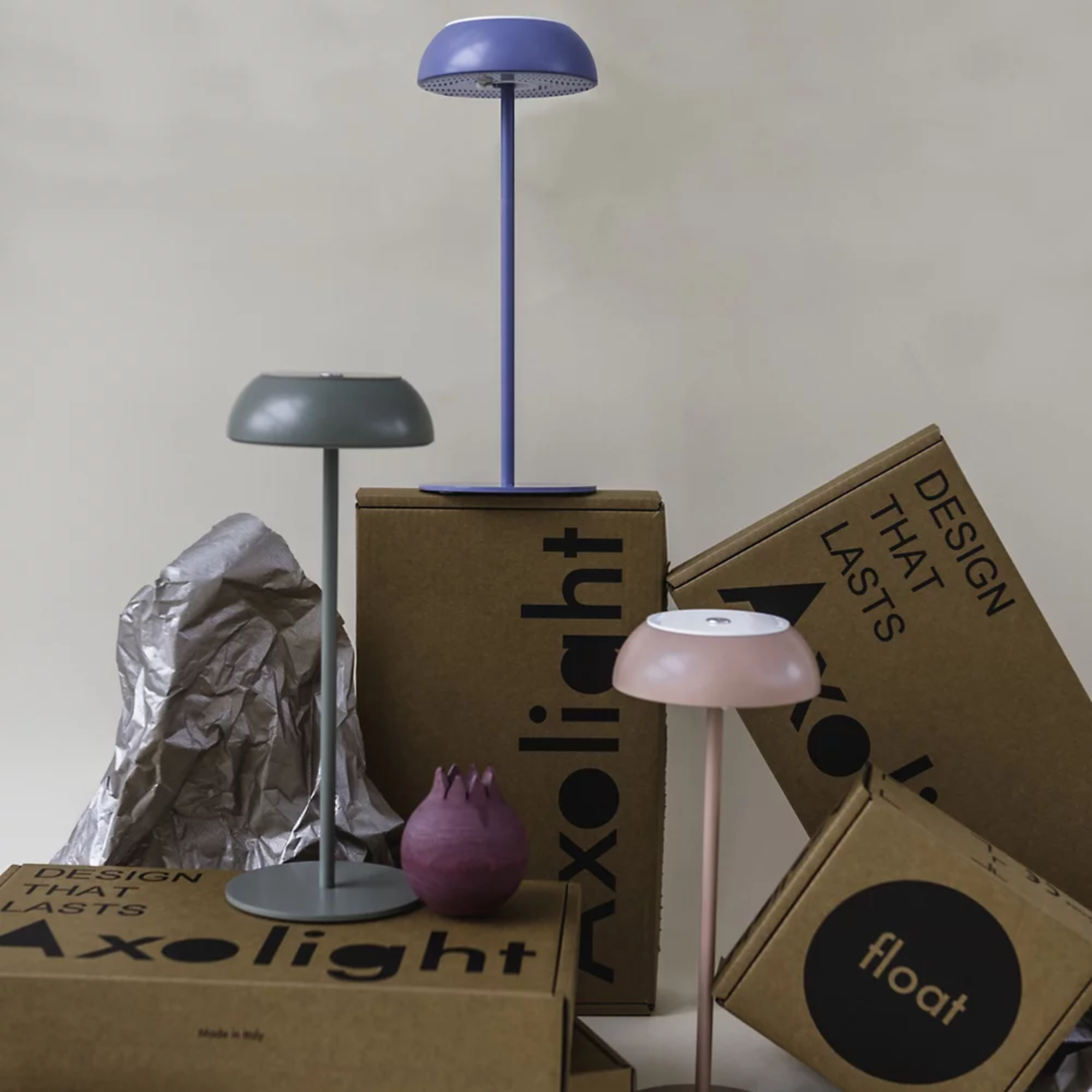 The blue, mauve dust and concrete green Float Cordless Lamp from Axolight in a living room. all-groups