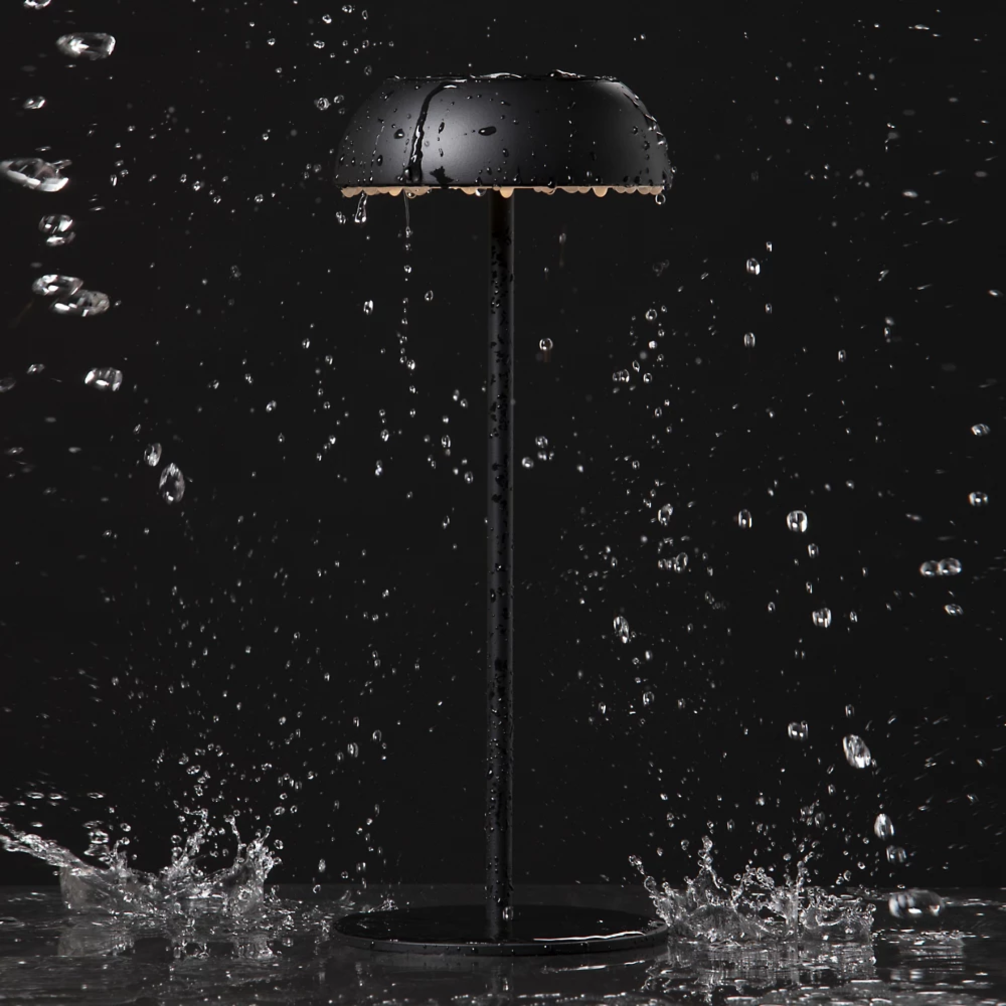 The black Float Cordless Lamp from Axolight showing its waterproof features. all-groups