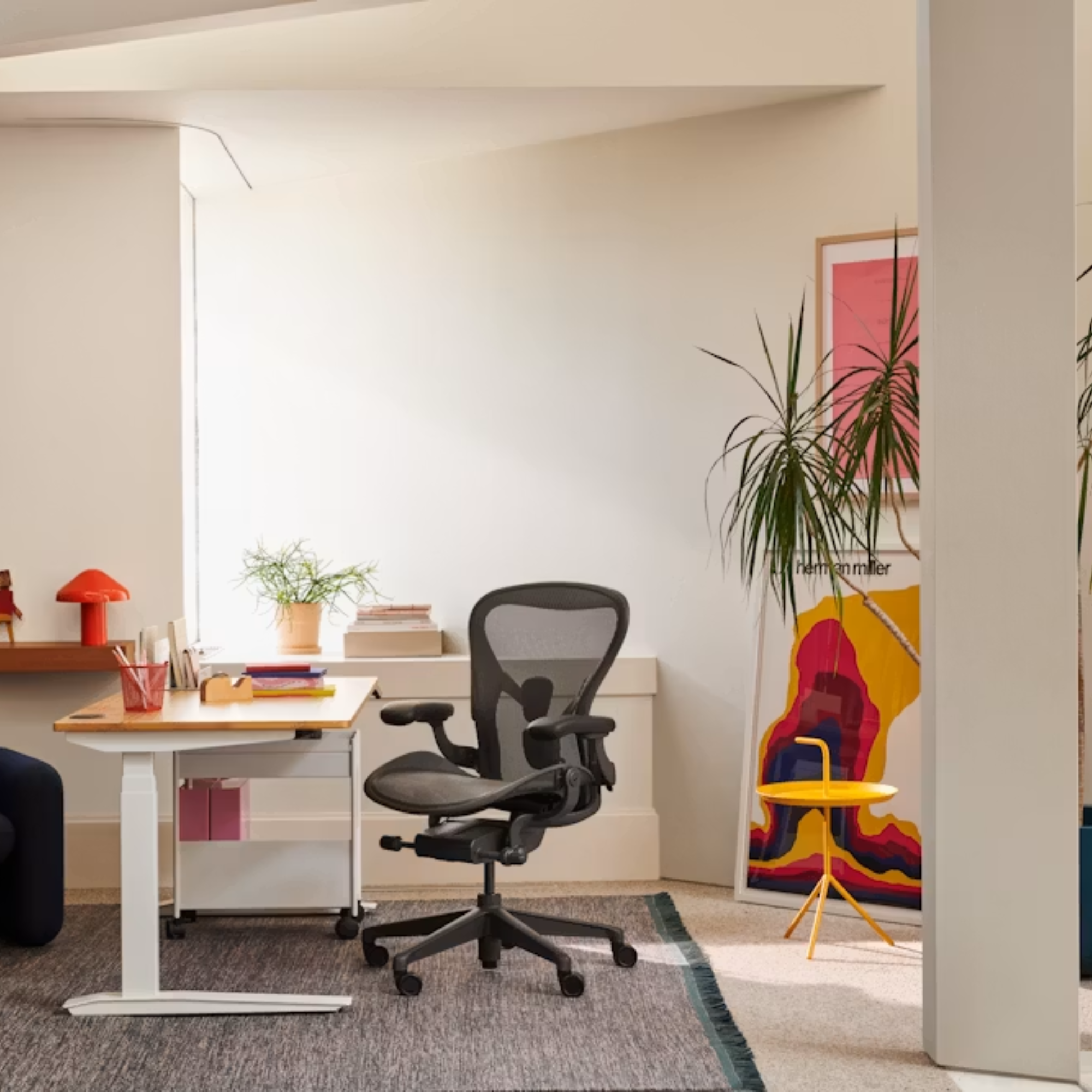 The Aeron Office Chair from Herman Miller at a desk within an office used for making and selling art.