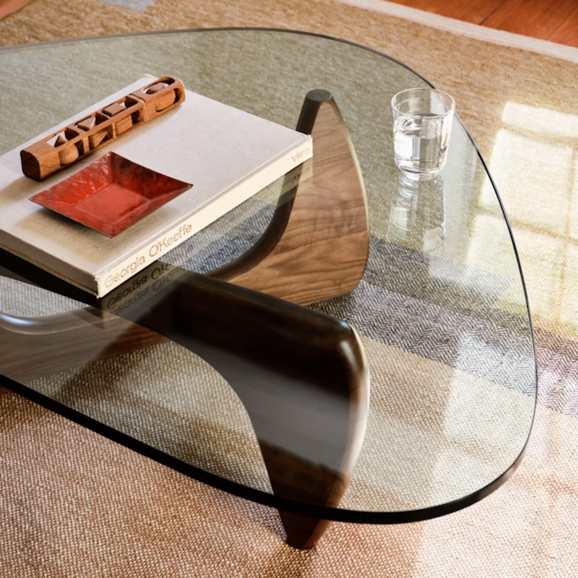 The walnut Noguchi Table from Herman Miller in a home office on top of a rug.