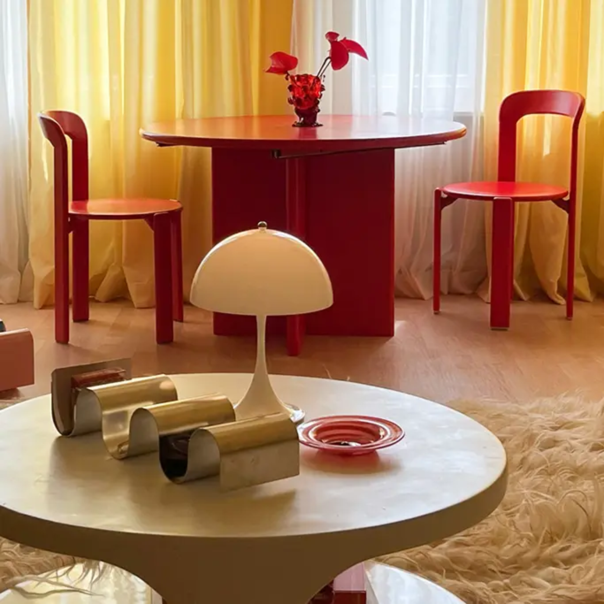 The opal Panthella 250 Portable Lamp from Louis Poulsen in a living room on a coffee table.