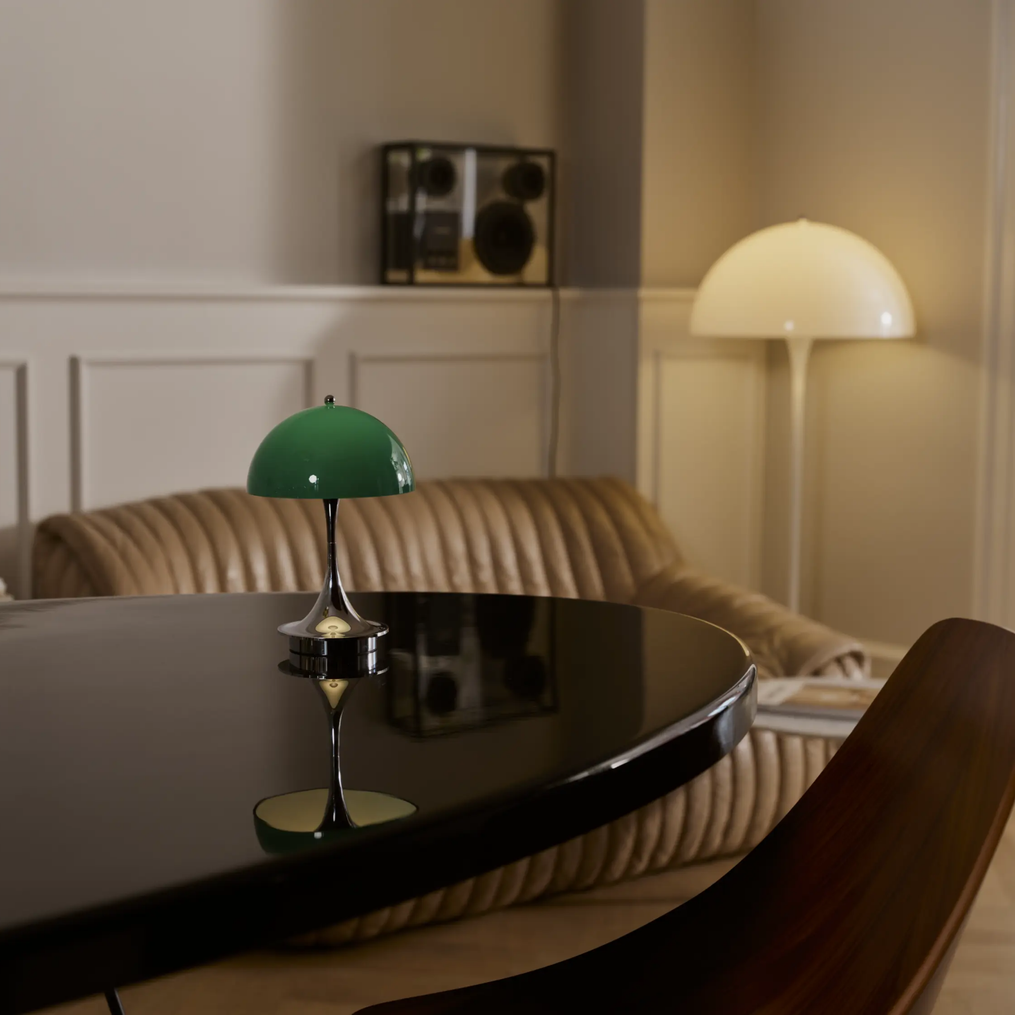 The 9.5 inch green Panthella Portable Lamp: The Originals from Louis Poulsen in a meeting room on top of a table.