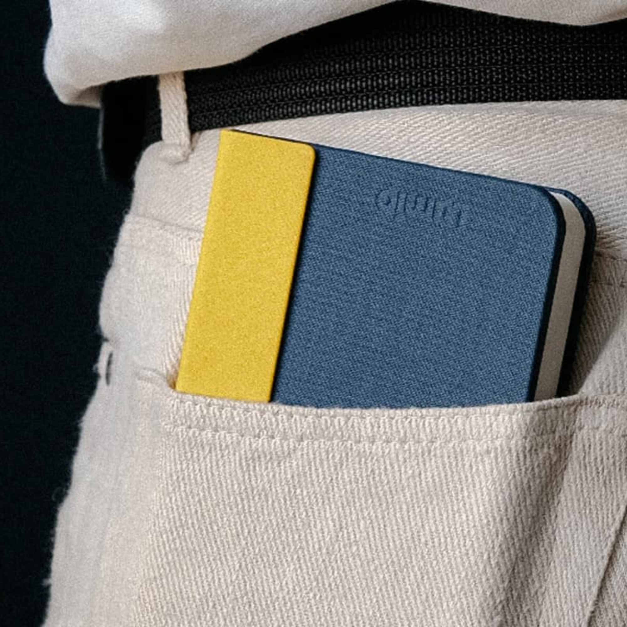 The Lito Mini Cordless Book Lamp from Lumio in a living room in a models pant's pocket. all-groups