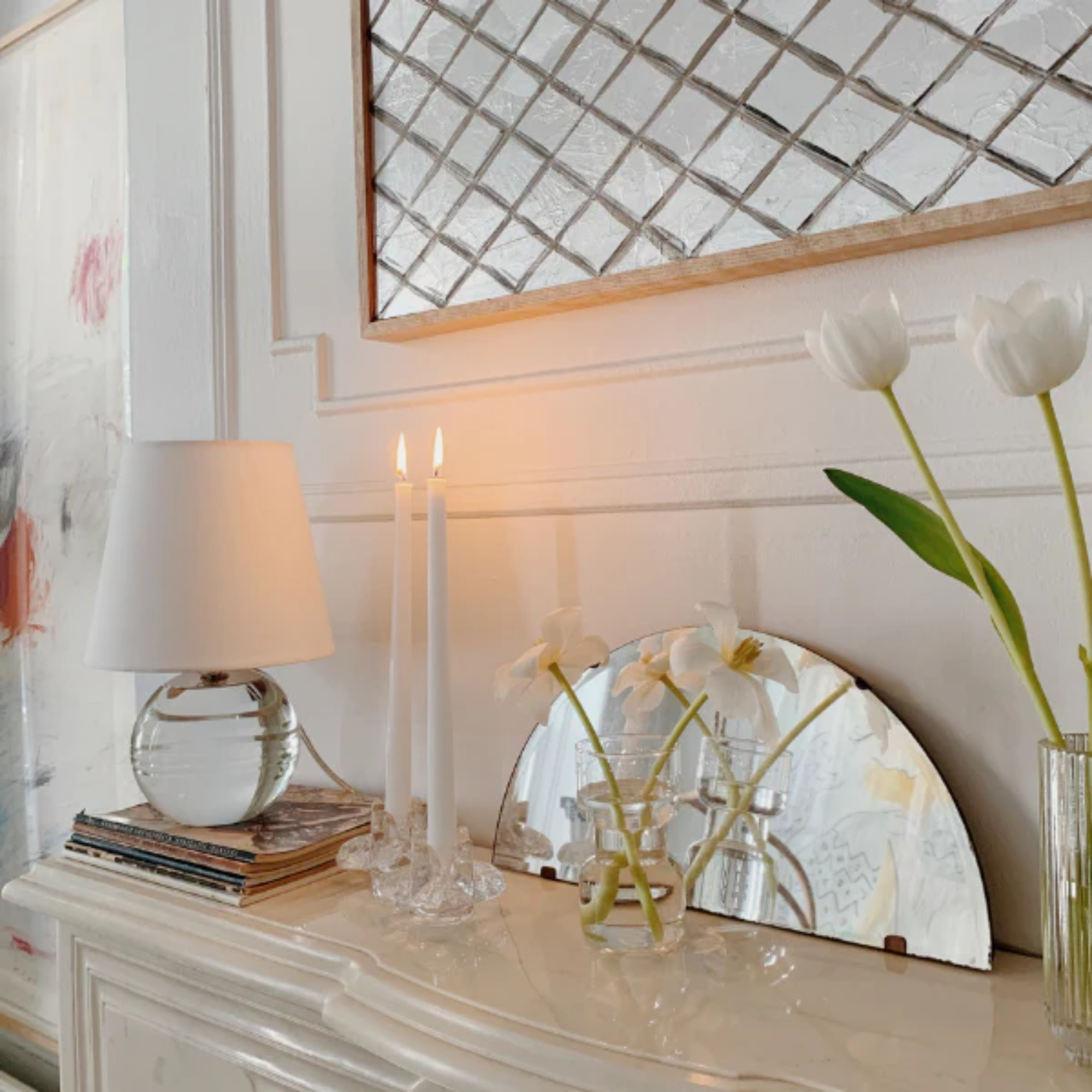 The Nicole Rechargeable LED Table Lamp from Mitzi in a family area beside two candles.