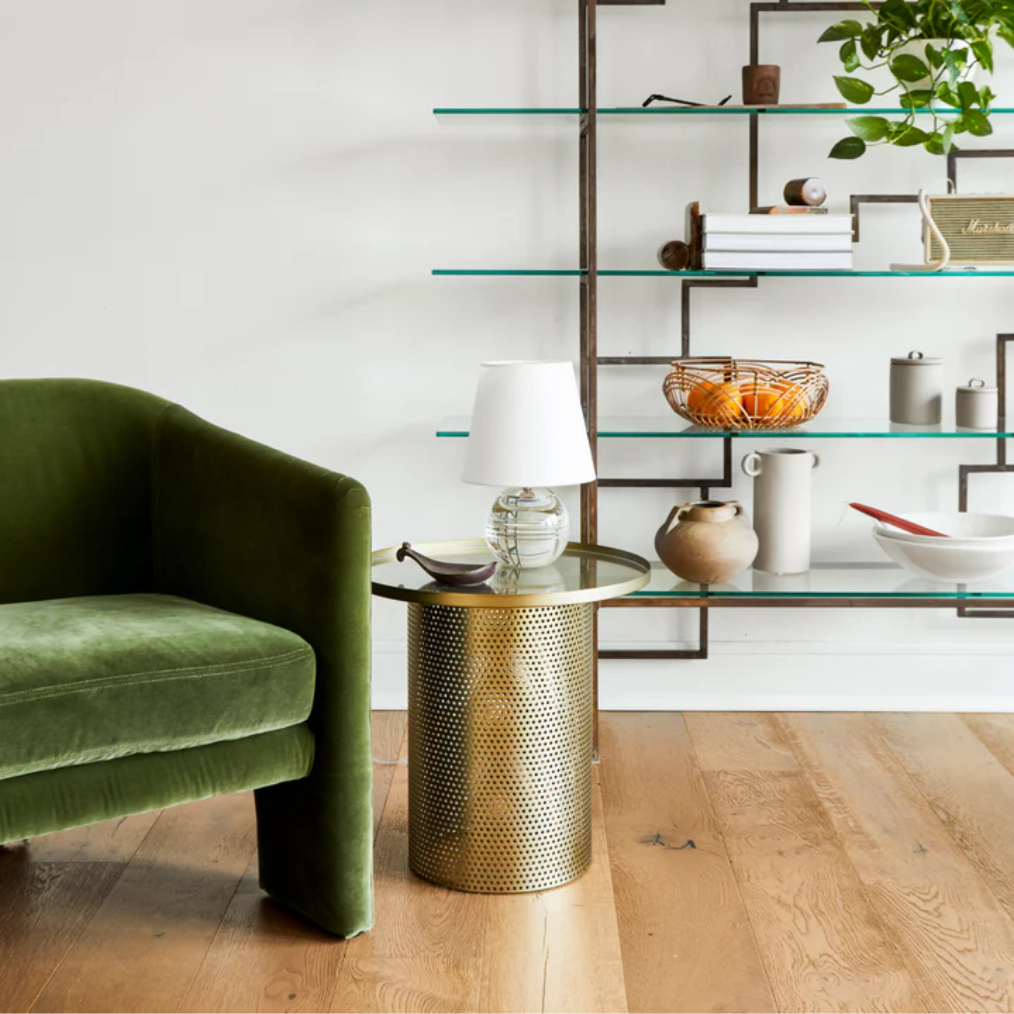 The Nicole Rechargeable LED Table Lamp from Mitzi in a home office on top of an accent table beside a chair.