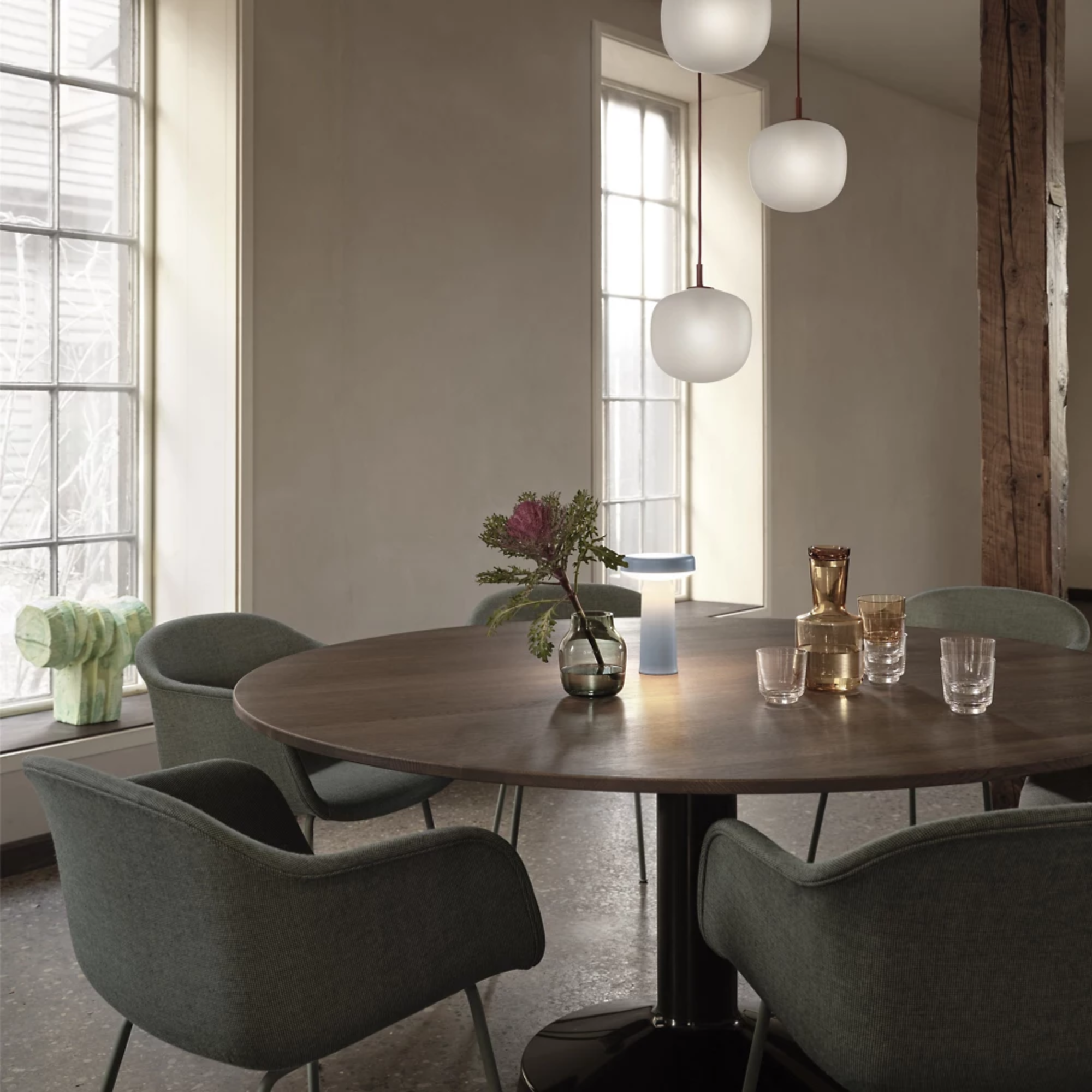 The light blue Ease Cordless Lamp from Muuto in a dining area on top of a dining table.