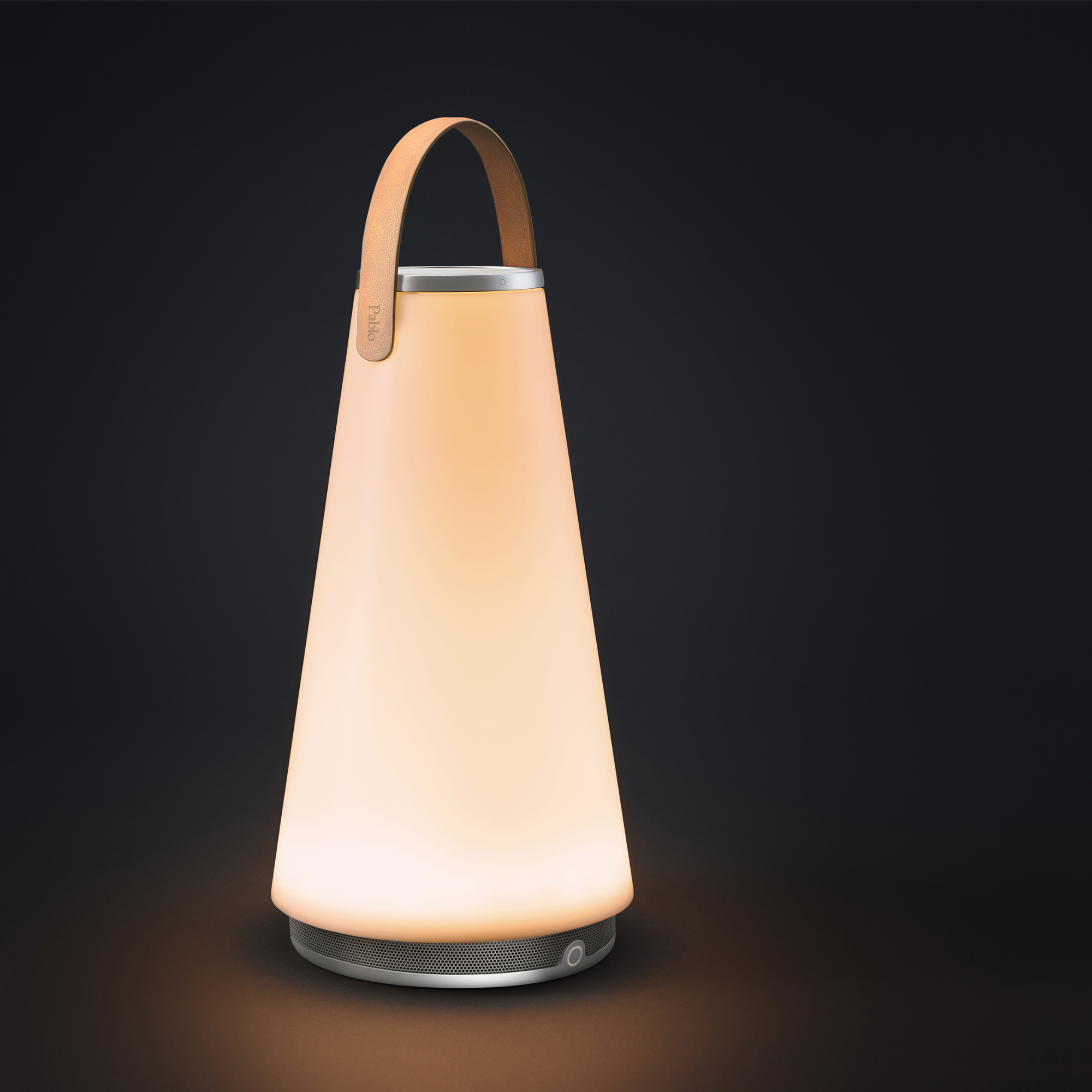 The Uma Sound Table Lamp from Pablo Designs in a studio at an angle.