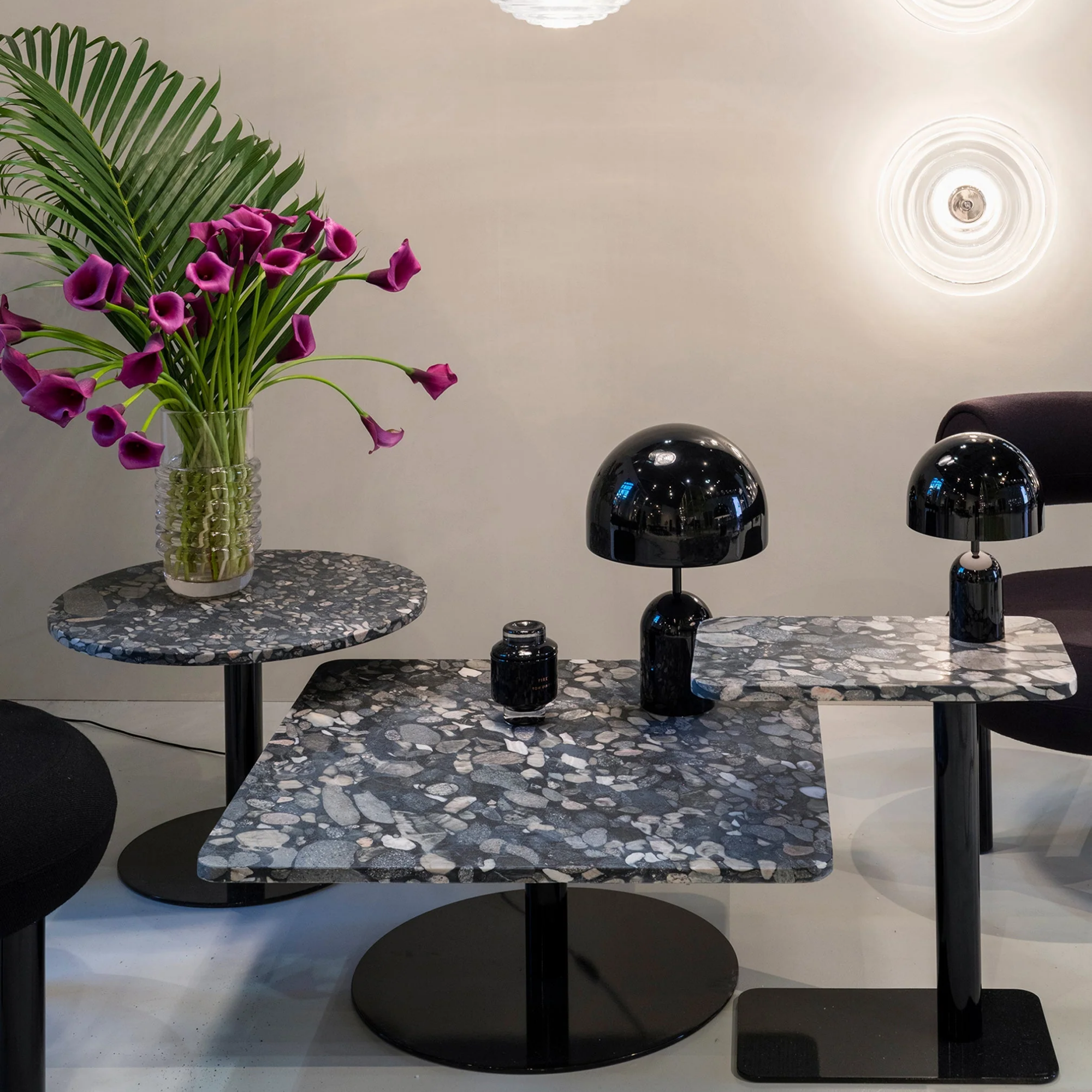 The black Bell Cordless Lamp from Tom Dixon in a business space on top of a table.