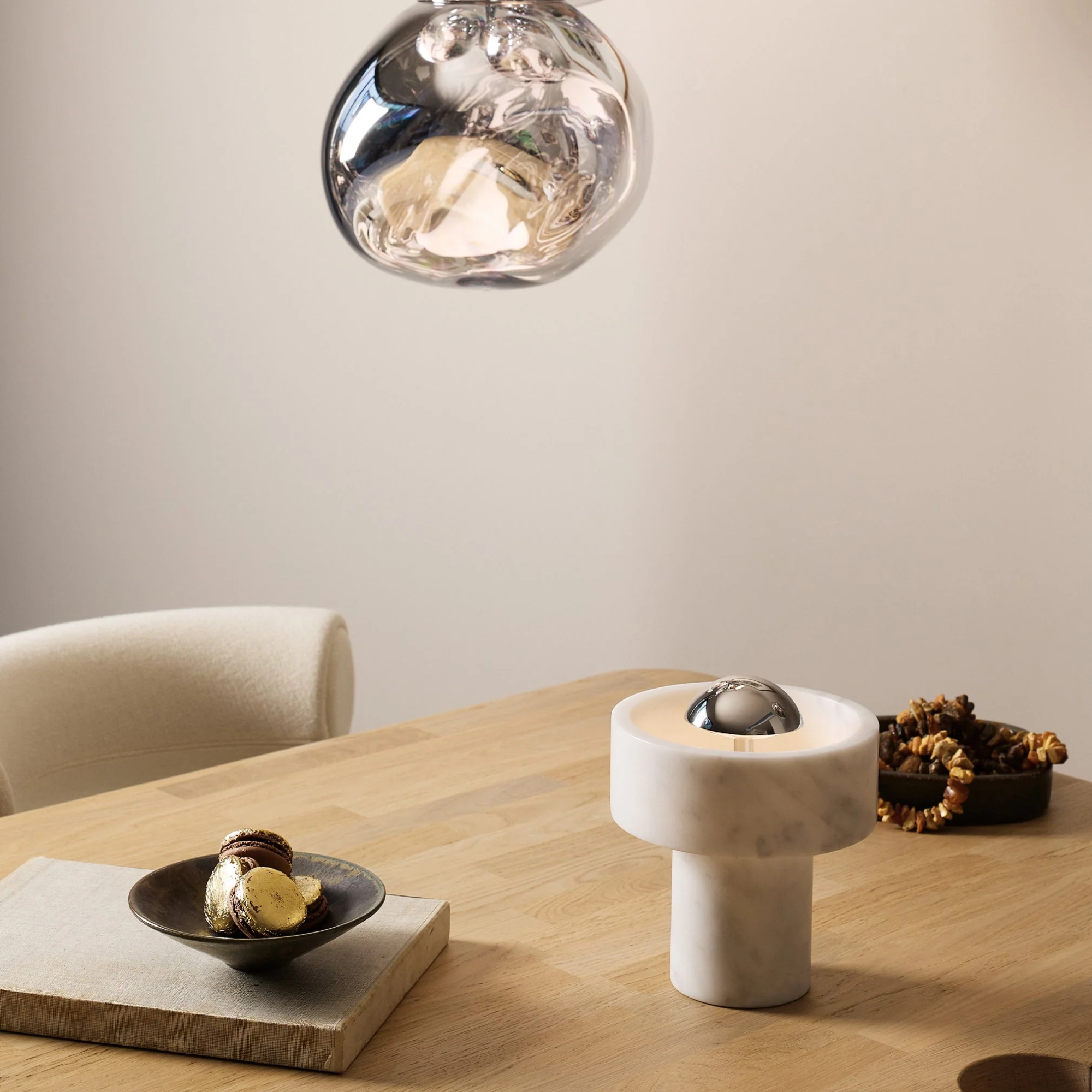 The silver Stone Cordless Lamp from Tom Dixon in a dining room on a dining room table.