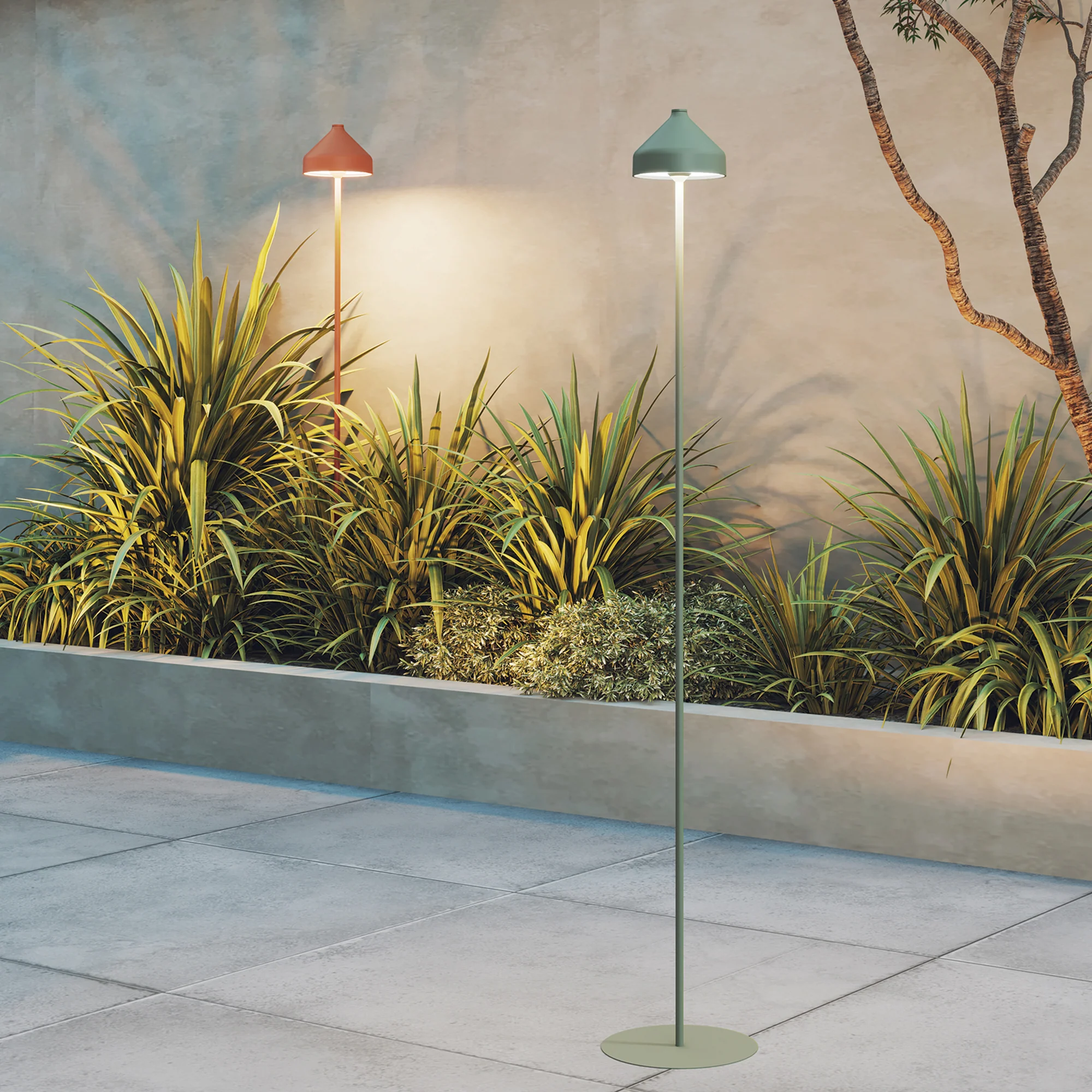The sage green Amelie Pro Cordless Floor Lamp from Zafferano in an outdoor terrace nearby plants.