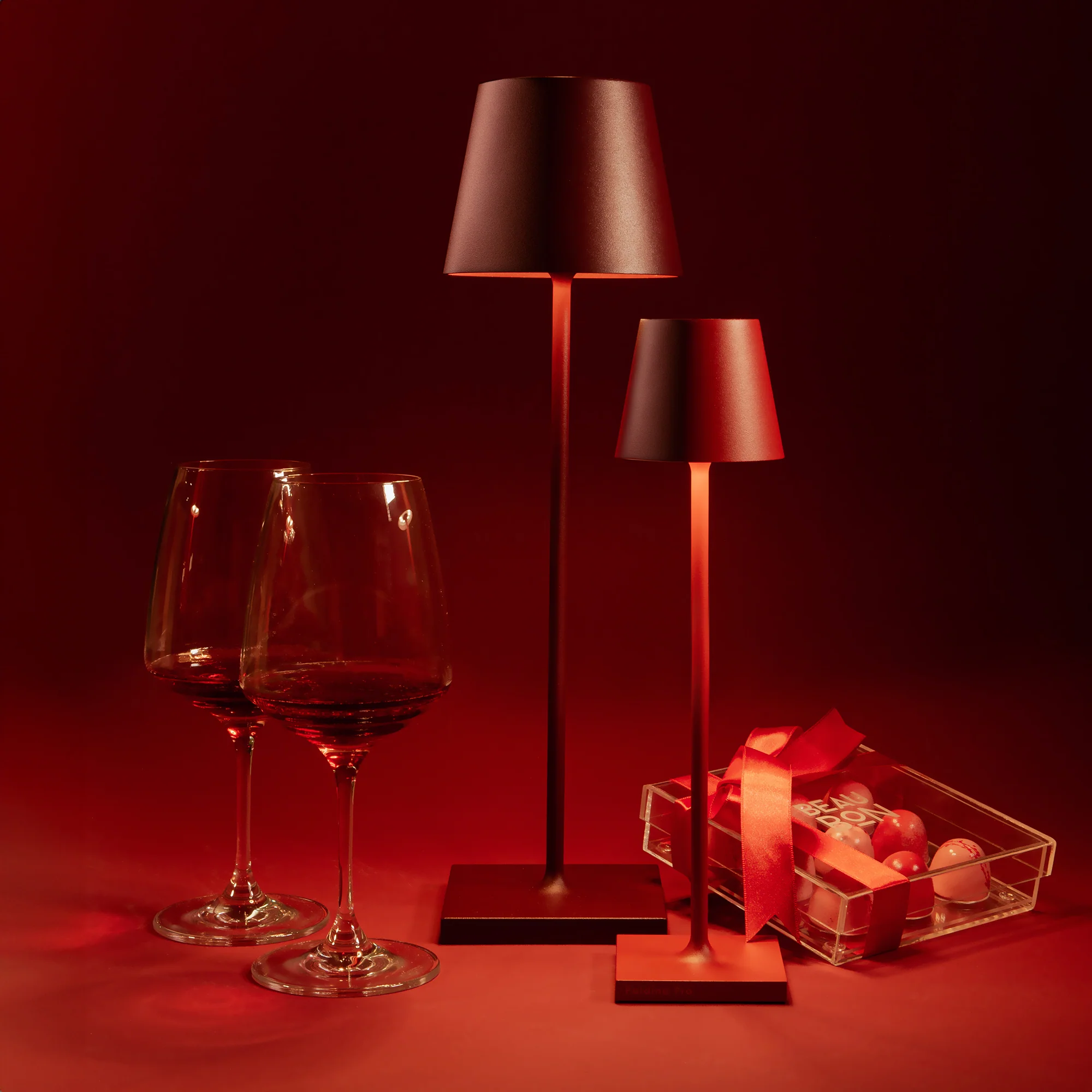 The bordeaux Poldina Pro from Zafferano in a living room with wine glasses and chocolates.