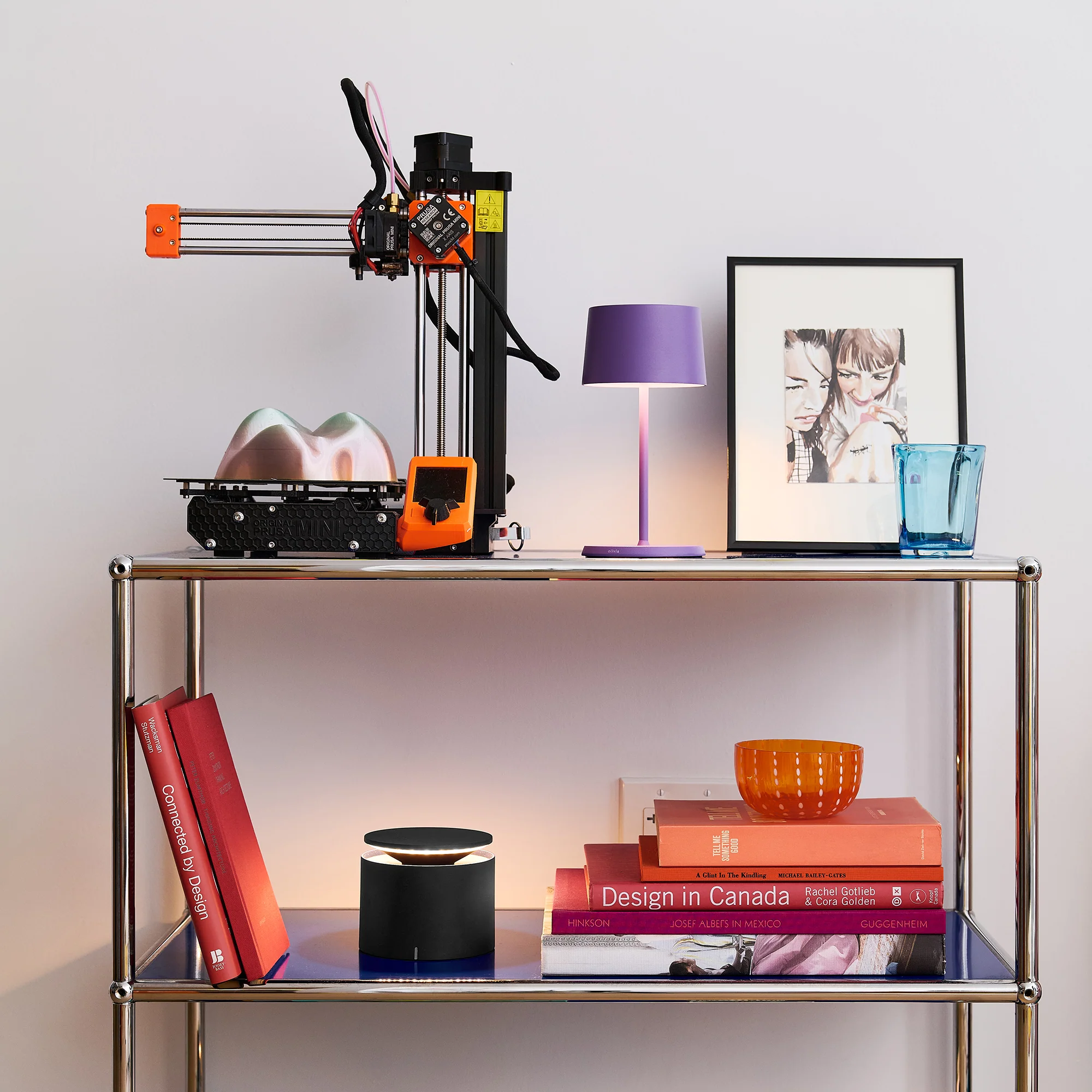 The dark grey PushUp Pro Cordless Lamp from Zafferano in a kids room with various decor.