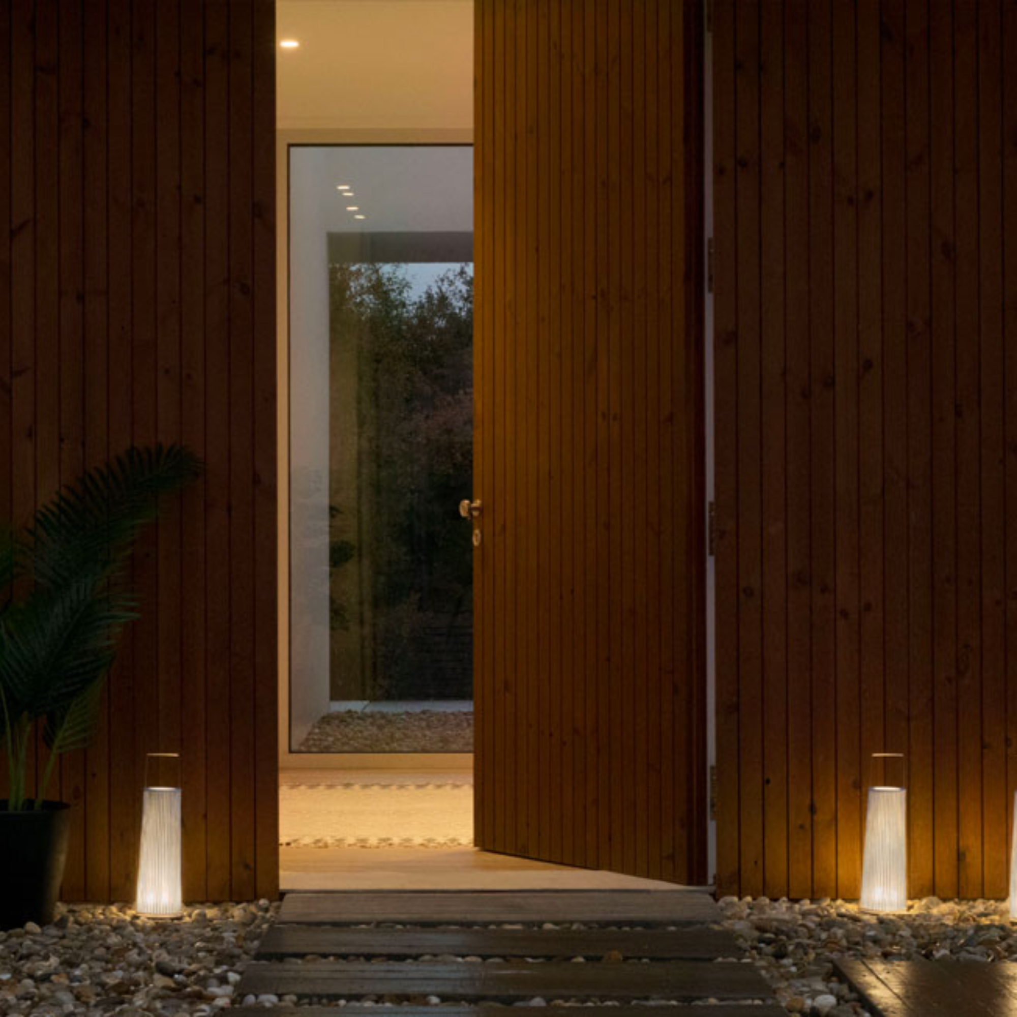 The Hipatia Cordless Lamp from a-emotional light in a doorway.