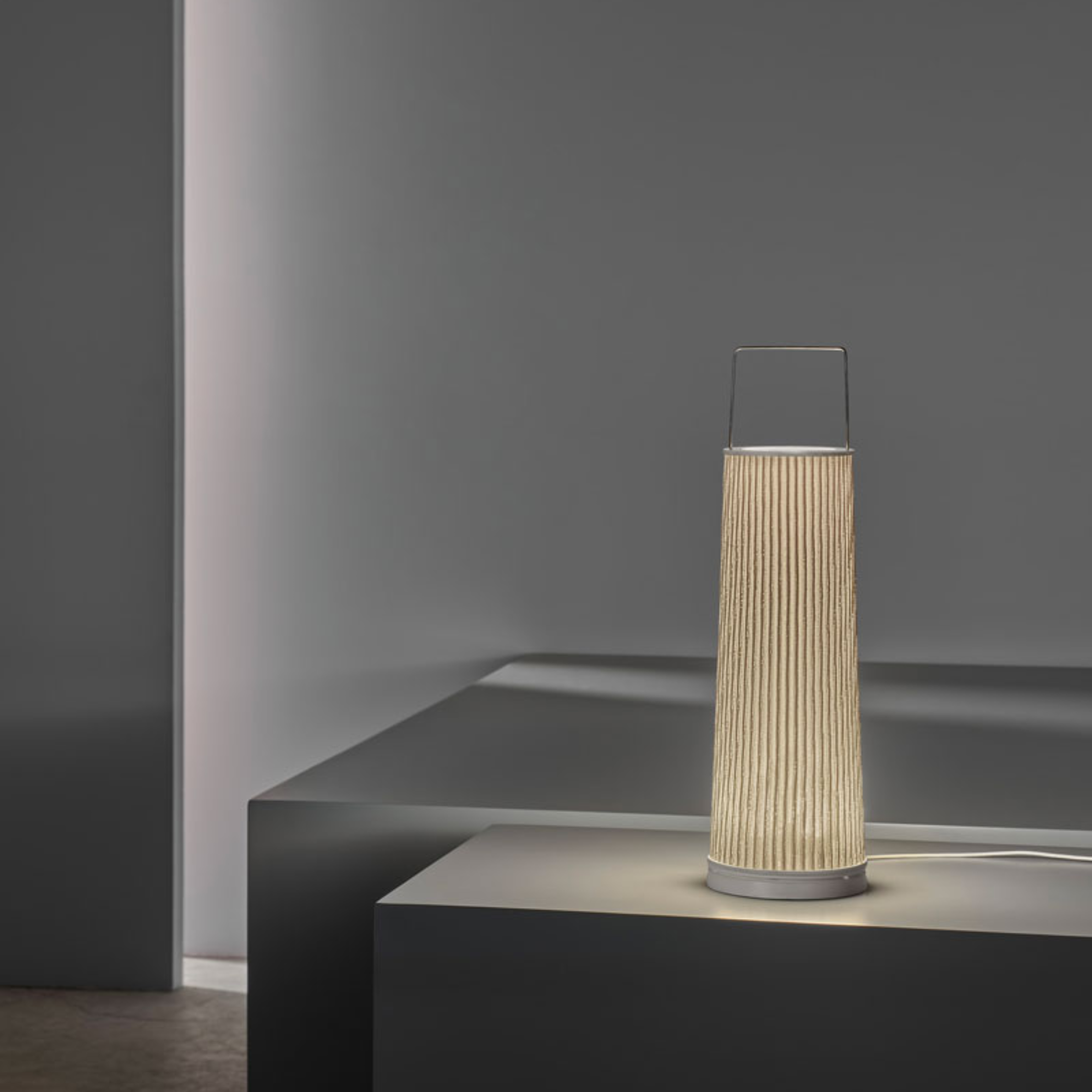 The Hipatia Cordless Lamp from a-emotional light in a home office.