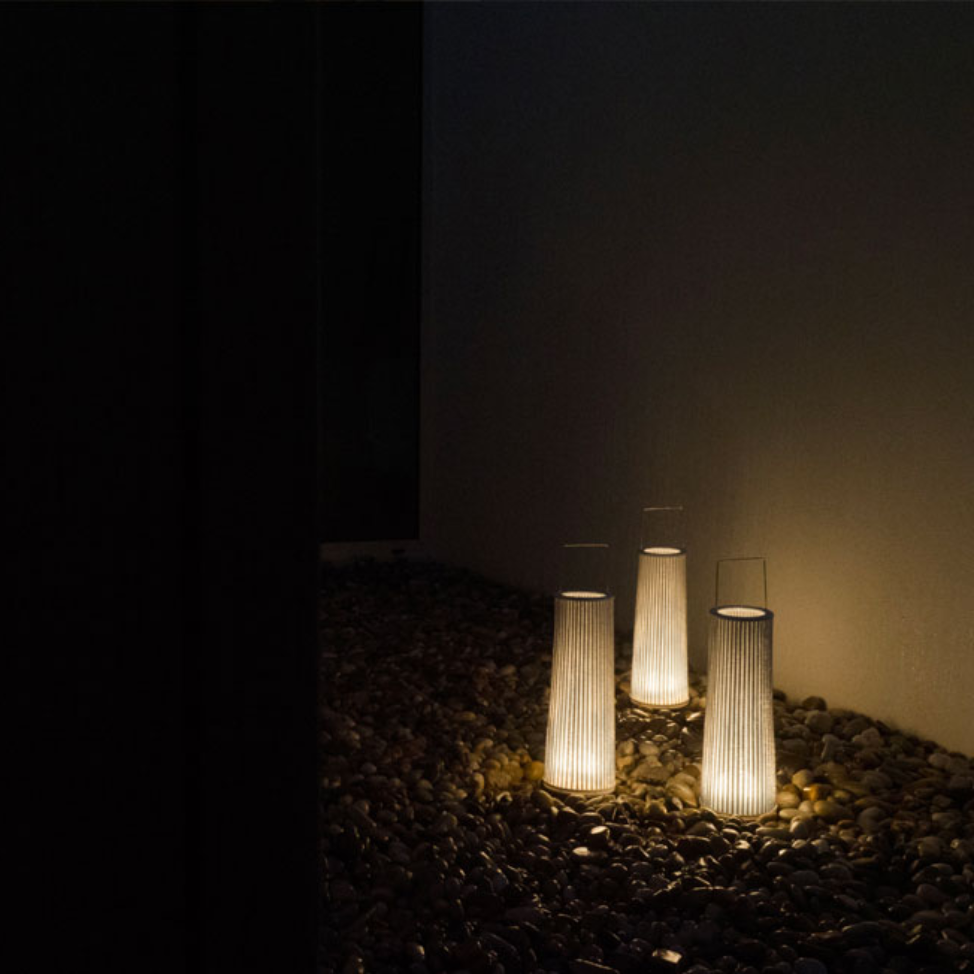 The Hipatia Cordless Lamp from a-emotional light in an outdoor living space.