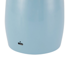 The cerulean Poppy Cordless Lamp from Alora Mood charging port.