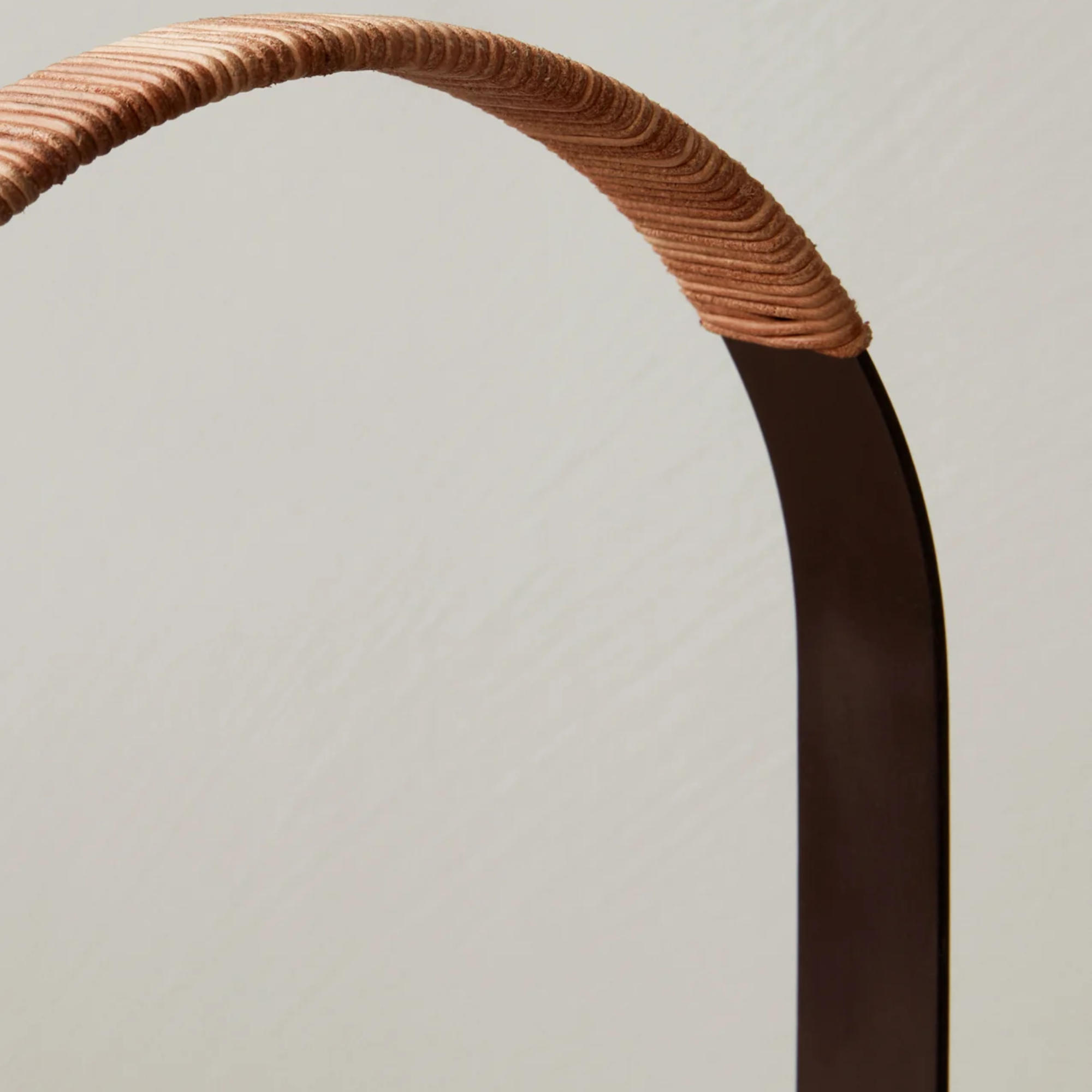 The bronzed brass Carrie Portable Table Lamp from Audo Copenhagen leather handle in detail.