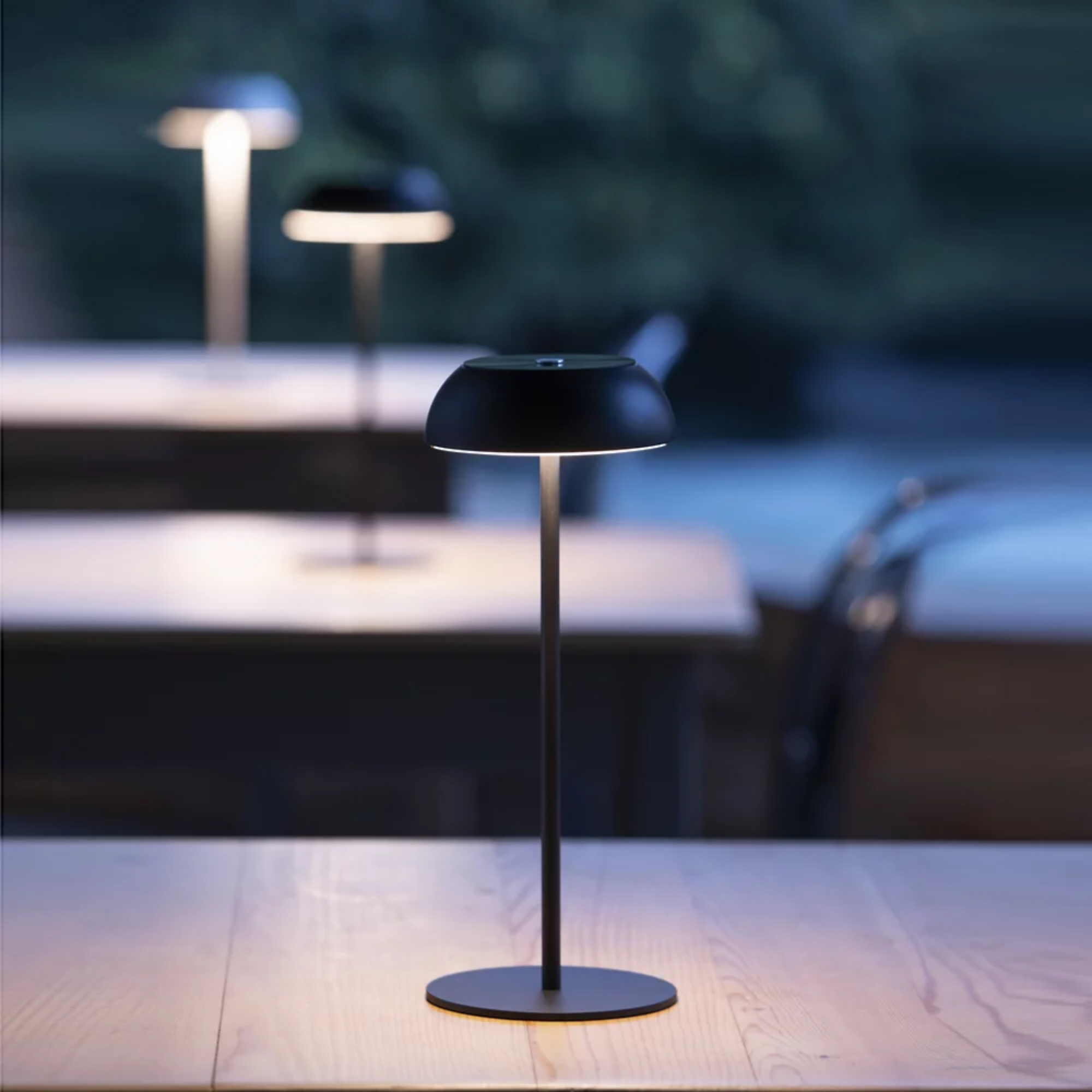 The black Float Cordless Lamp from Axolight in an outdoor restaurant. all-groups