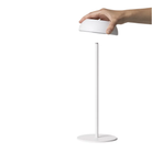 The white Float Cordless Lamp from Axolight showing the detachable led light and it's table lamp stand. all-groups