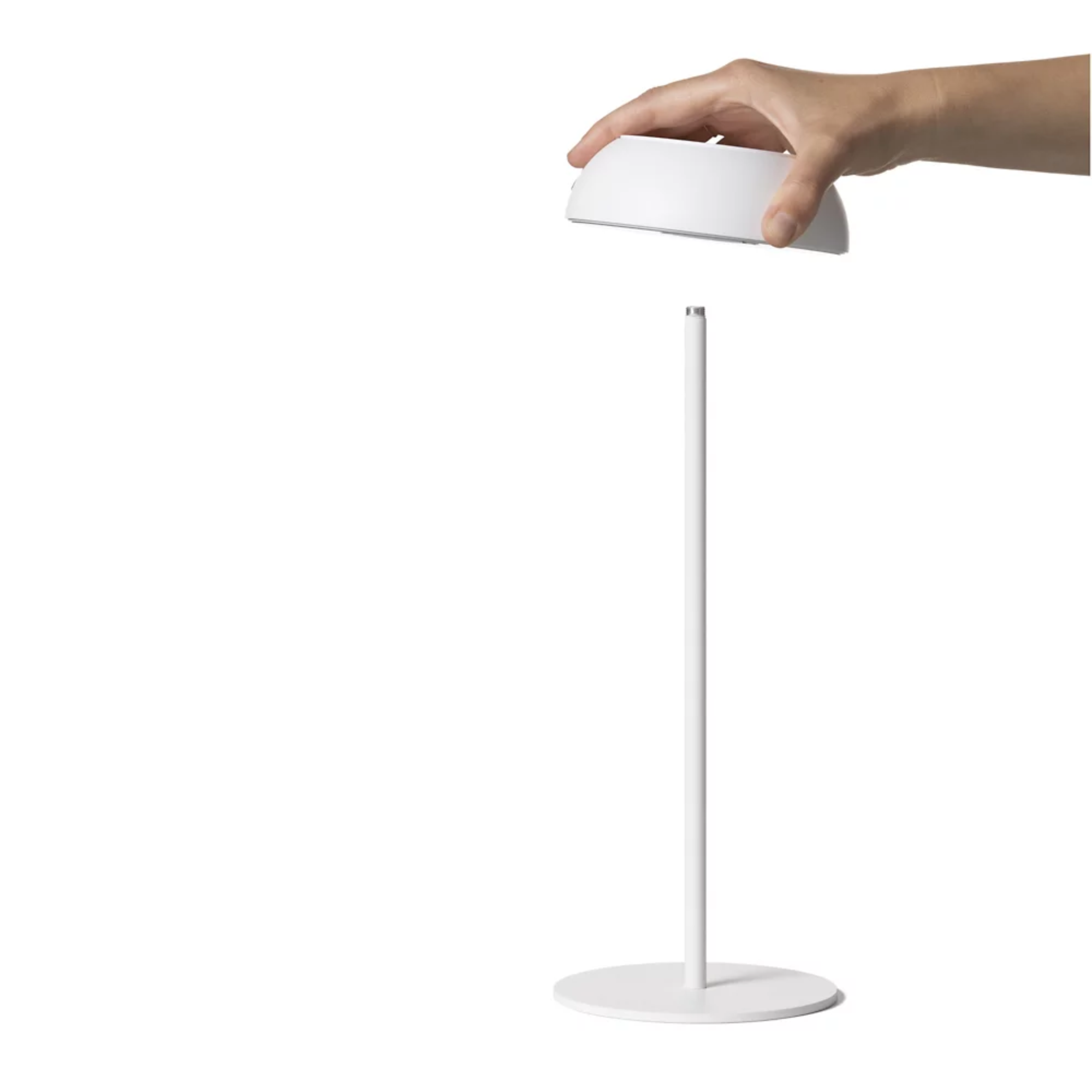 The white Float Cordless Lamp from Axolight showing the detachable led light and it's table lamp stand. all-groups