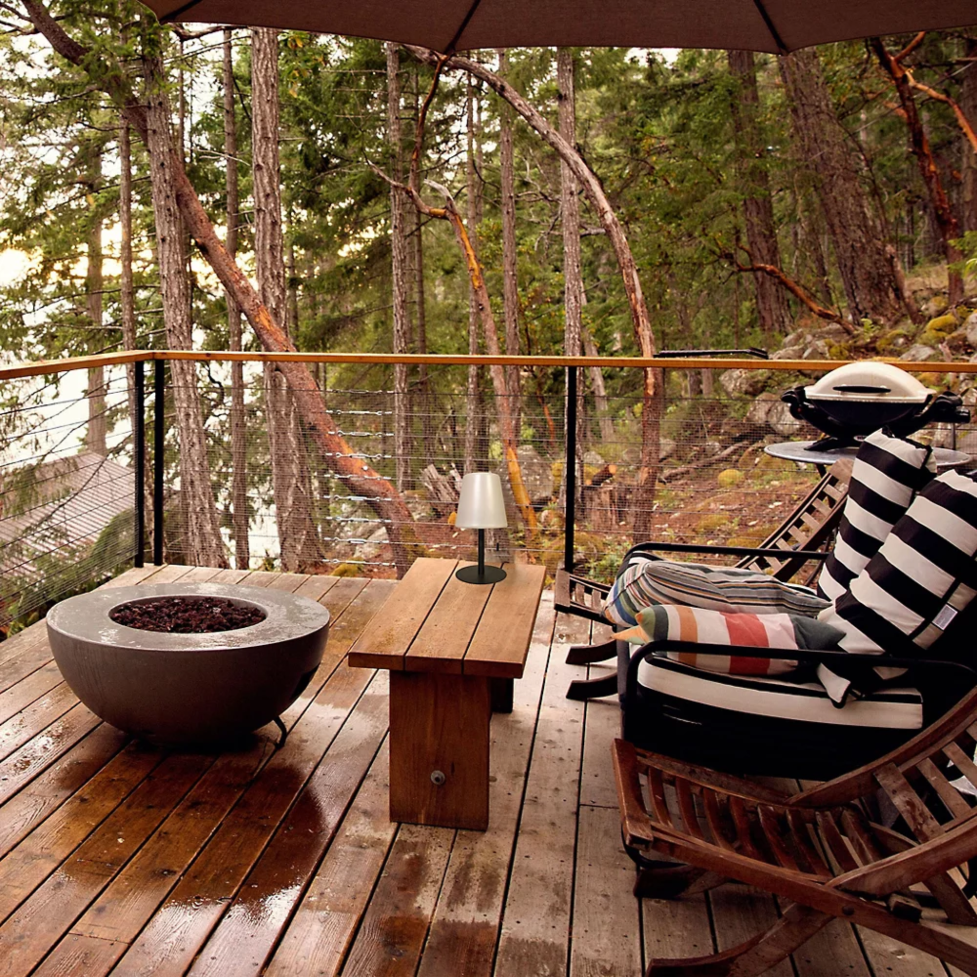 The Tinsley Cordless Table Lamp from Dainolite on an outdoor patio protected by an umbrella.