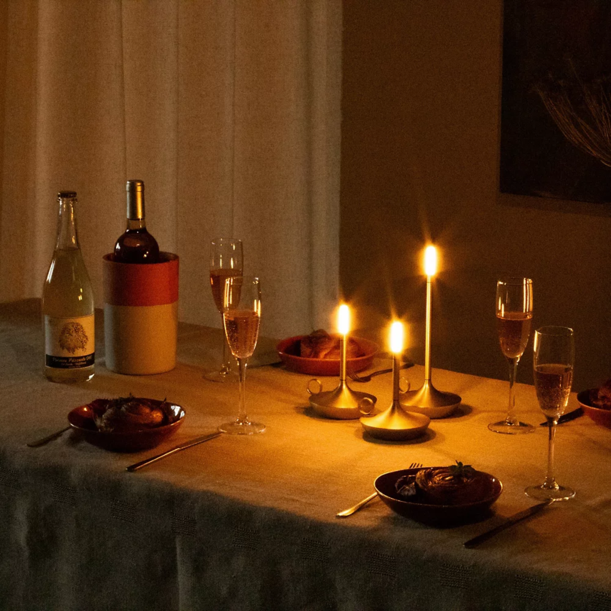 The Wick Pro Cordless Lamp from Graypants in a dinning toom table, lighting up the room. all-groups
