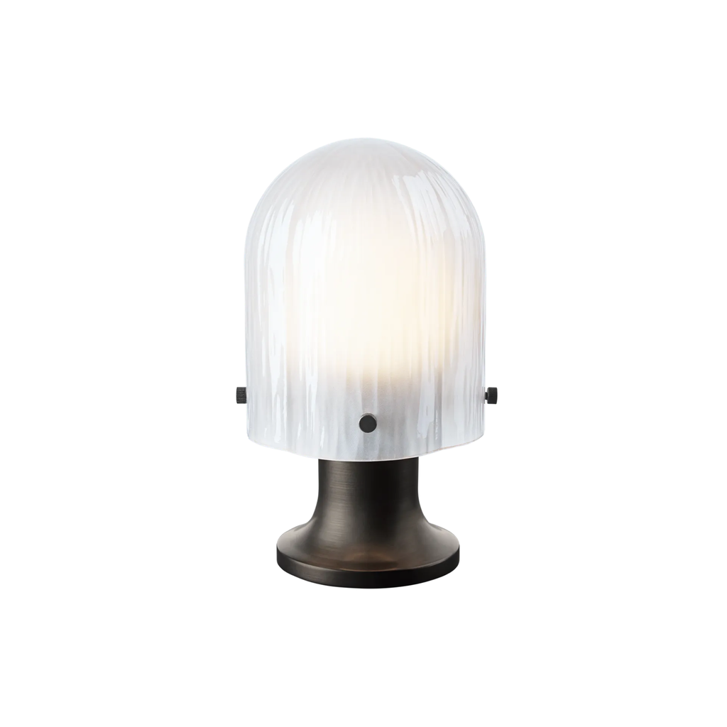 The Seine Portable Table Lamp from GUBI dimmed.