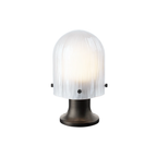 The Seine Portable Table Lamp from GUBI dimmed.