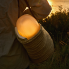 The Seine Portable Table Lamp from GUBI used for outdoor dining.