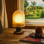 The Seine Portable Table Lamp from GUBI in a primary bedroom.