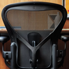 A close up of the adjustable posturefit SL backing of the black and onyx Aeron Office Chair from Herman Miller.