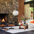 The walnut Noguchi Table from Herman Miller in a designer home in the center of a living room.
