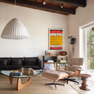 The white oak Noguchi Table from Herman Miller in a living room next to an Eames Lounge Chair and Ottoman.
