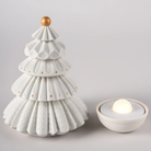 The Christmas Tree Cordless Table Lamp from Lladro shown in a studio, with the LED base separate from the tree shade.