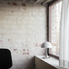 The grey opal Panthella 160 Portable Lamp from Louis Poulsen in a living room on the windowsill.