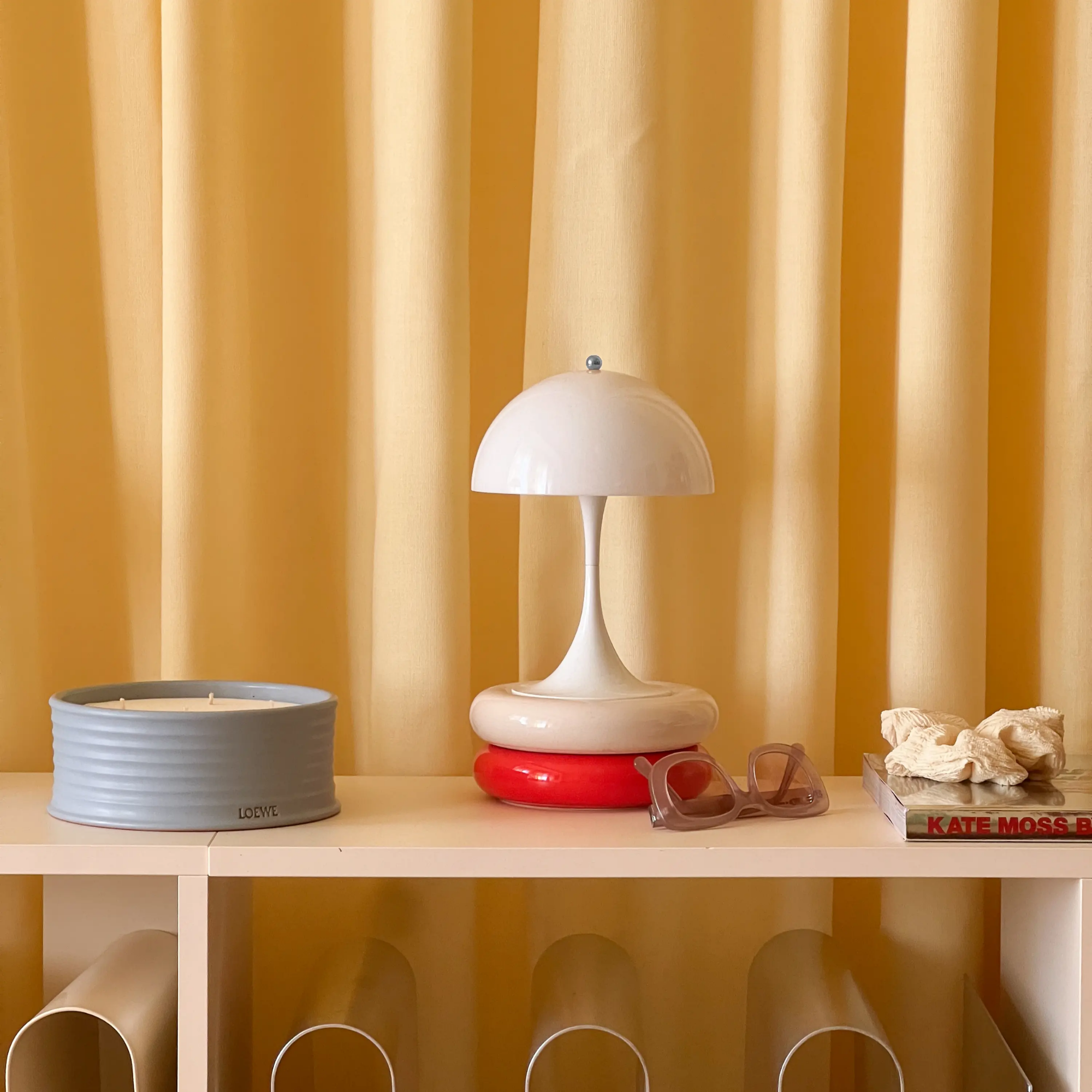 The opal Panthella 160 Portable Lamp from Louis Poulsen in a home office with other decor.