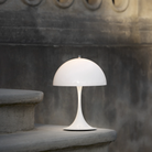 The opal Panthella 250 Portable Lamp from Louis Poulsen on an outdoor staircase.
