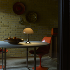 The 13.2 inch brown Panthella Portable Lamp: The Originals from Louis Poulsen in a home office on top of dining room table.