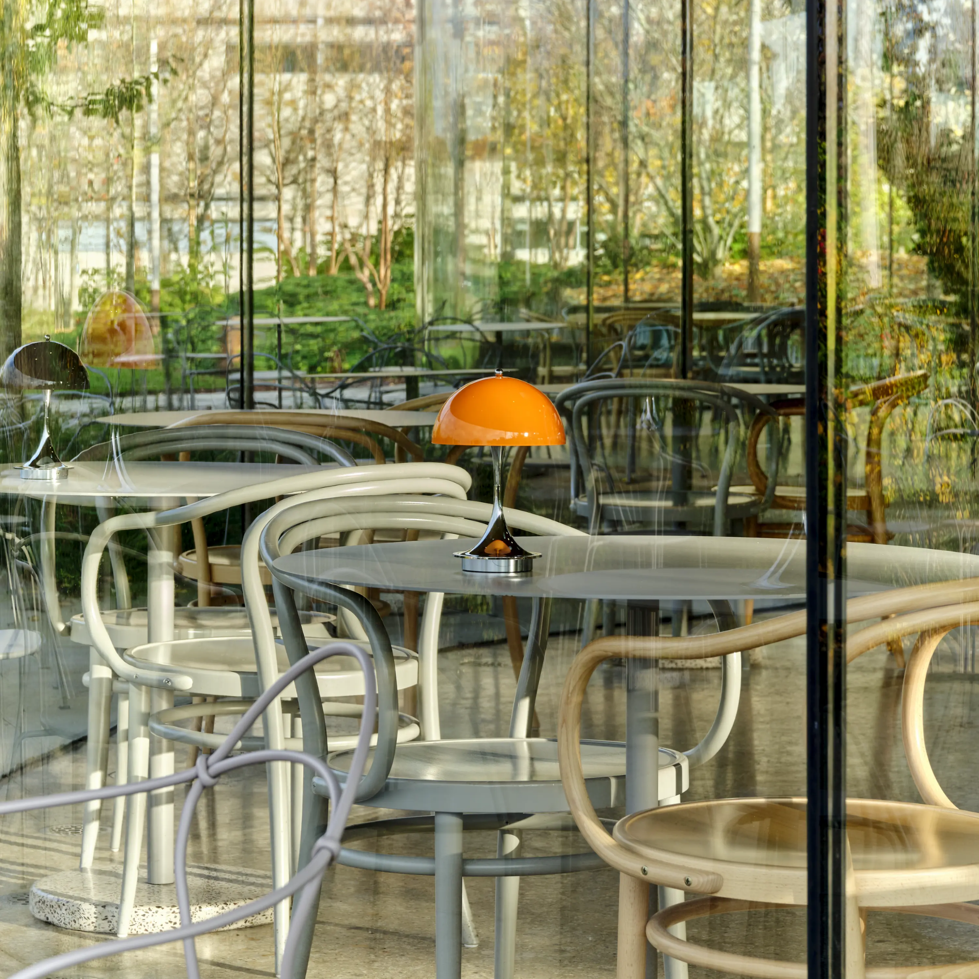 The 9.5 inch orange Panthella Portable Lamp: The Originals from Louis Poulsen in a restaurant.