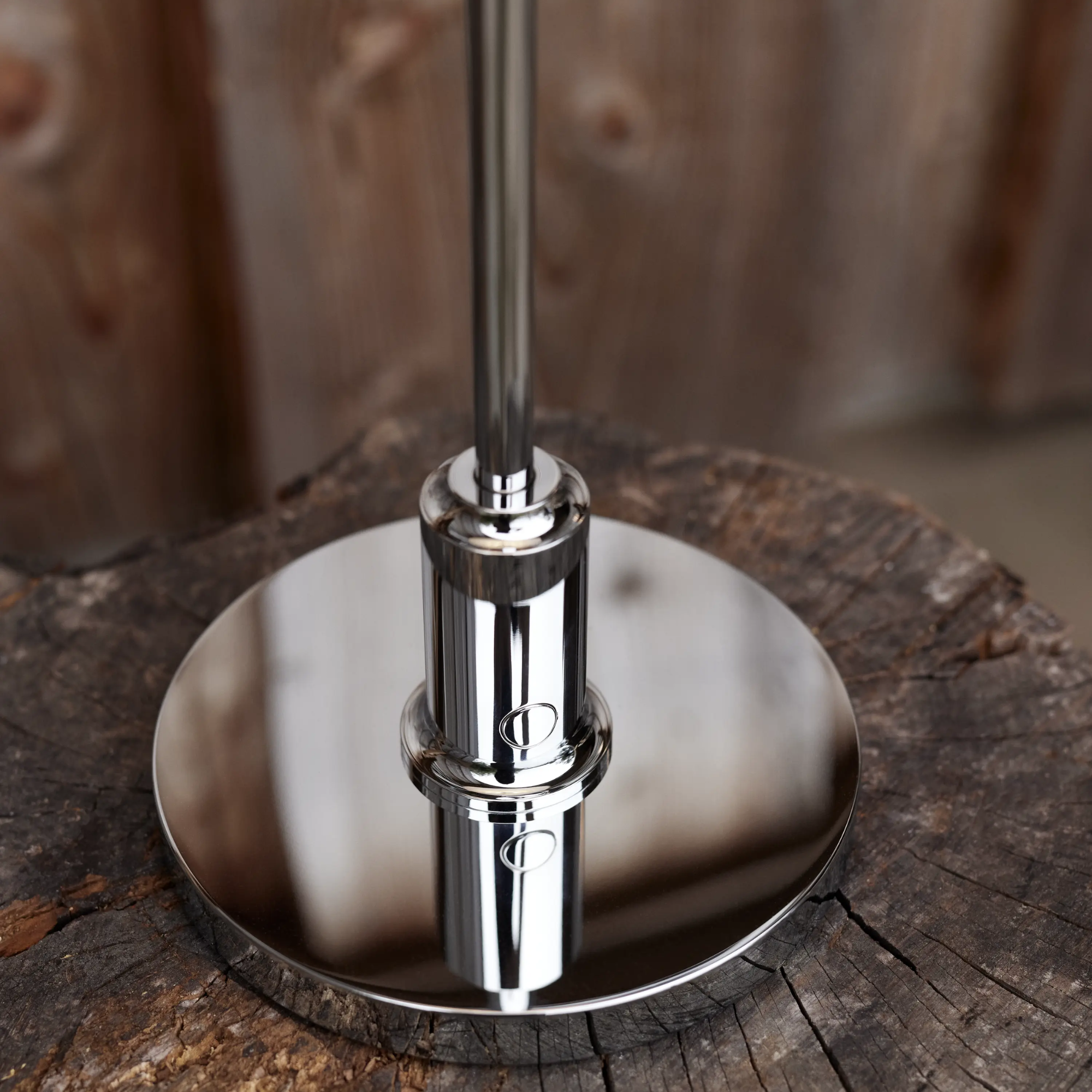 The chrome PH 2/1 Portable Lamp from Louis Poulsen on a bedside table close up.