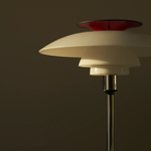 The opal white and high luster chrome plate PH 80 Portable Lamp from Louis Poulsen in a studio, close up.
