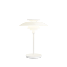 The opal white and white plate PH 80 Portable Lamp from Louis Poulsen turned on.