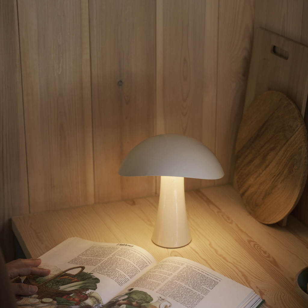 The cloud white Rumee 220 Portable Lamp from Louis Poulsen in a home office.