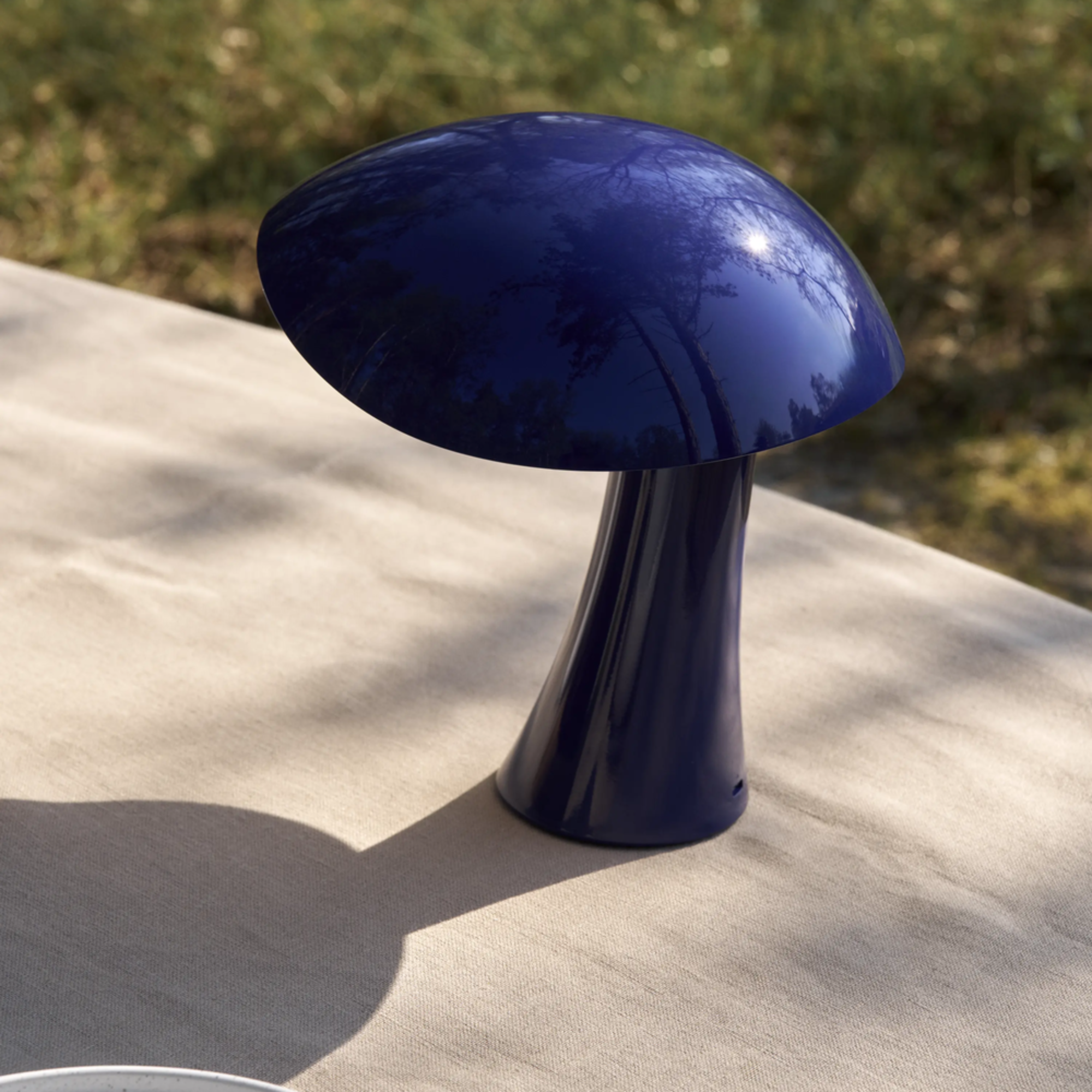 The night blue Rumee 220 Portable Lamp from Louis Poulsen used while camping.