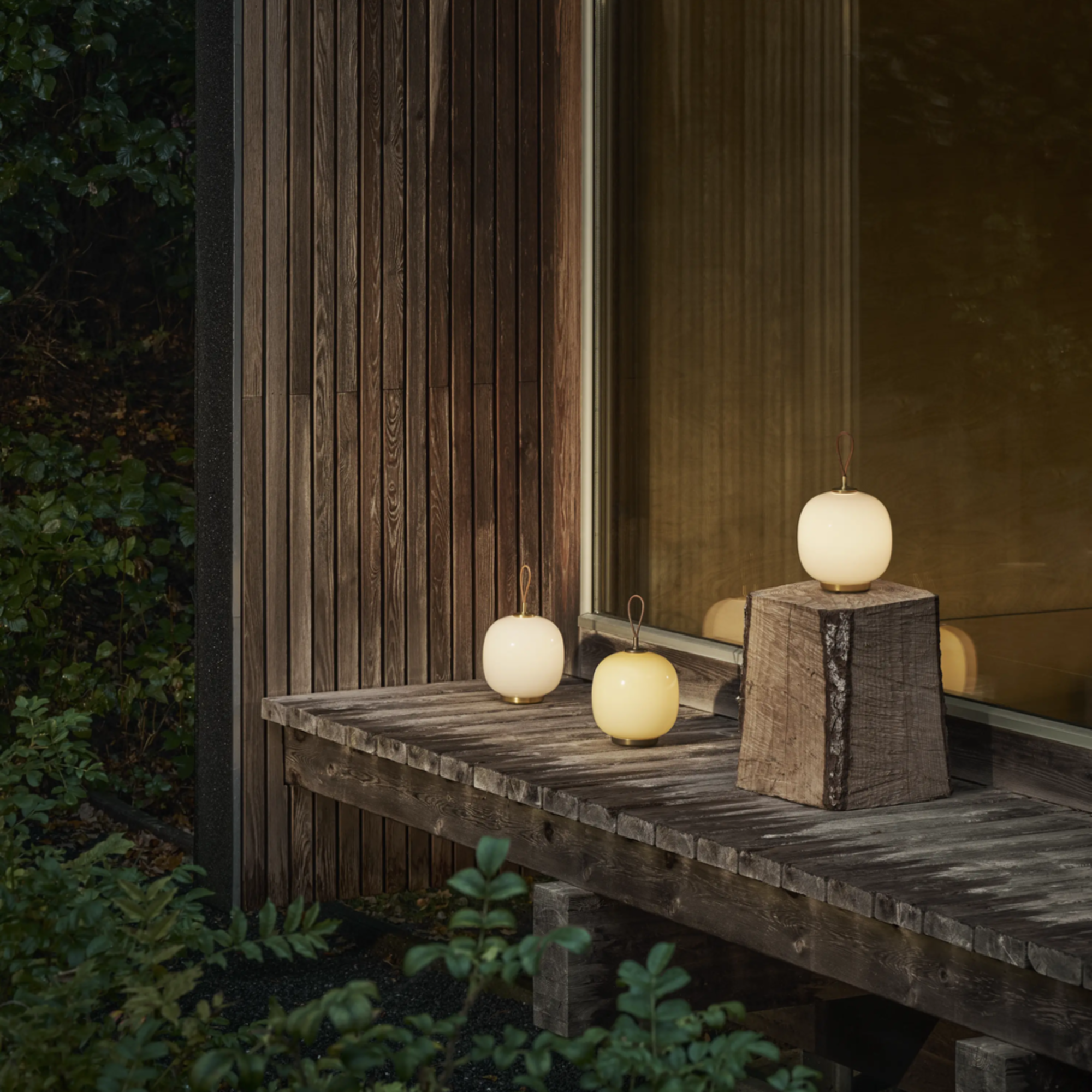 All three color options for the VL45 Radiohus Table Lamp from Louis Poulsen on an outdoor terrace. all-groups