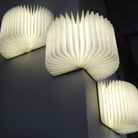 The Lito Classic Fabric Cordless Book Lamp from Lumio in a lounge mounted to the wall using magnets. all-groups