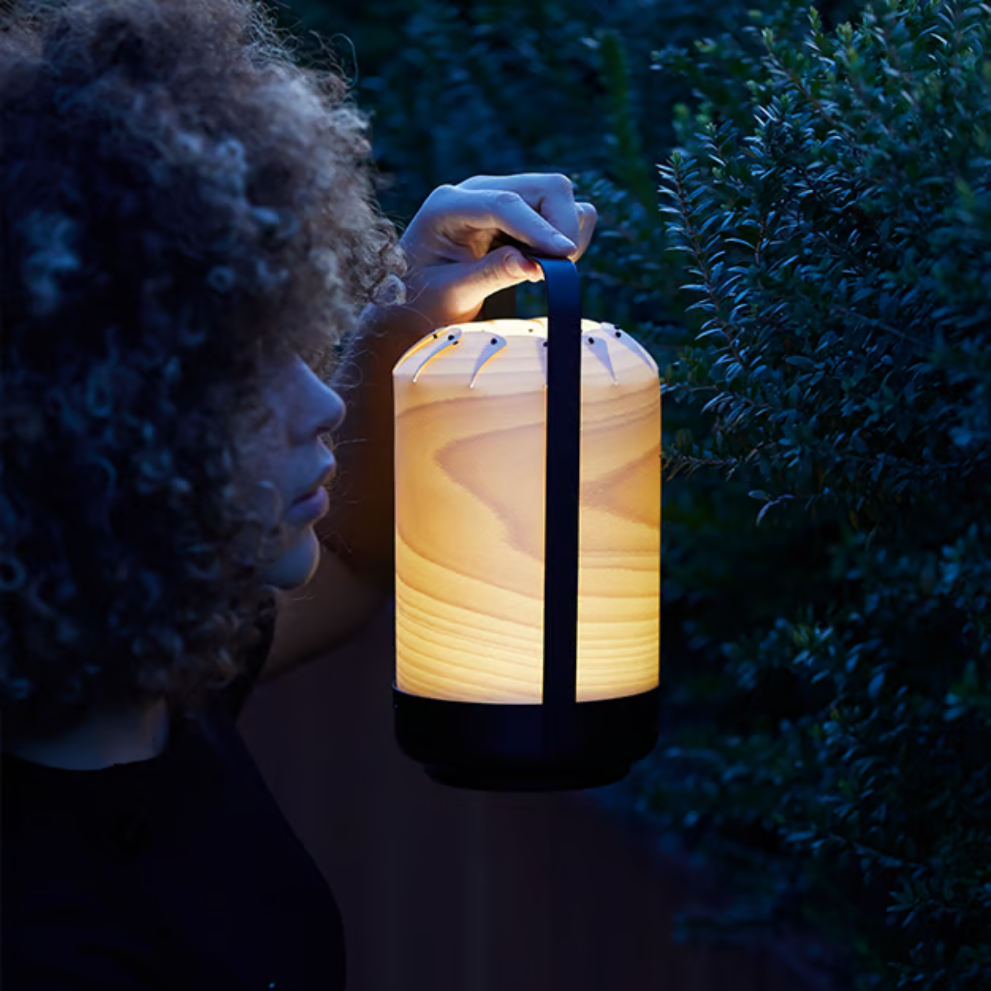 The Mini Chou Cordless Table Lamp from LZF in a garden. all-groups