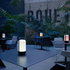 The Mini Chou Cordless Table Lamp from LZF in an outdoor dining space. all-groups