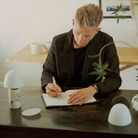 The Fuse Cordless Lamp from Made by Hand in a living room on top of a wooden table.